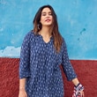 The model is wearing a floral blouse