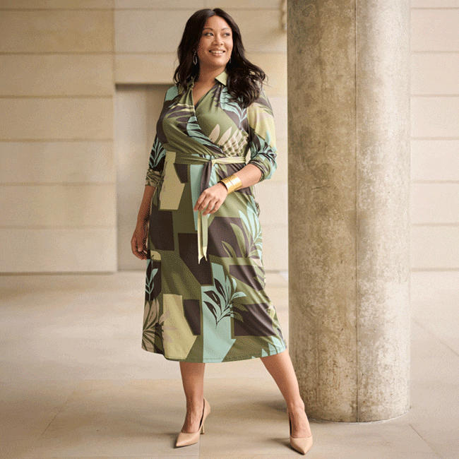 The model is wearing a red pantsuit