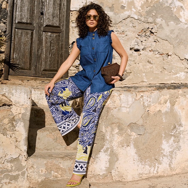 The model is wearing colorful pants