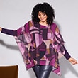 The model is wearing a patterned blouse with batwing sleeves 

