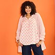 The model is wearing a pink jumper