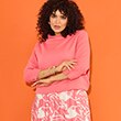 The model wears a pink patterned dress