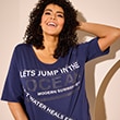 The model is wearing a purple printed T-shirt