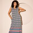 The model is wearing a purple and green patterned dress