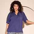 The model is wearing a purple blouse 