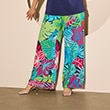 The model is wearing large-flowered wide trousers