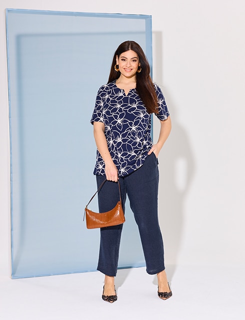 The model wears a blue tshirt with floral pattern

