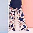 The model wears pants with big flowers

