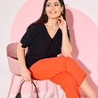 The model wears orange trousers
