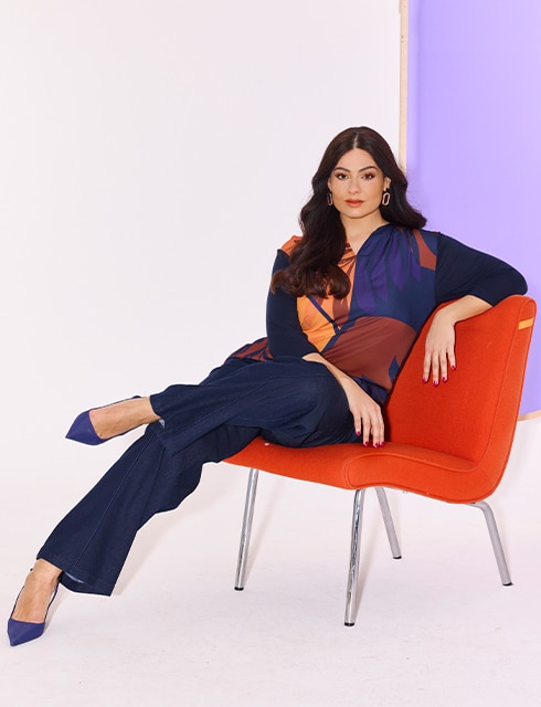 The model wears a colorful blouse