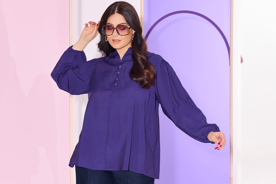 The model wears a purple blouse