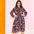 The model wears a colorful dress