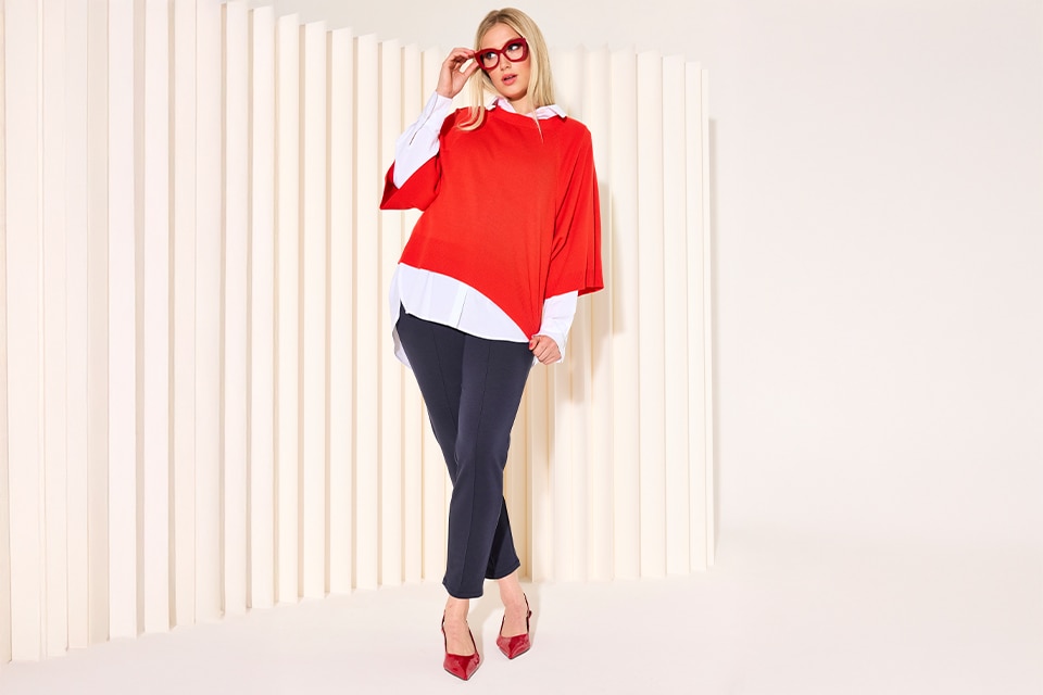 The model wears a orange cape