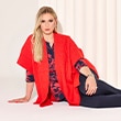 The model wears a red cardigan