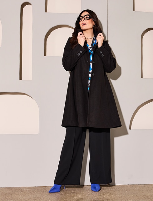 The model is wearing a black mini dress