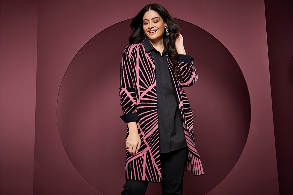 The model is wearing a dress with a graphic pattern.