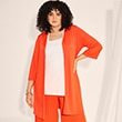 The model is wearing an orange cardigan