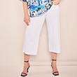 The model is wearing white trousers