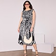 The model is wearing a black-and-white patterned dress.