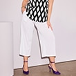 The model is wearing white trousers.
