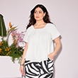 The model is wearing a white blouse.
