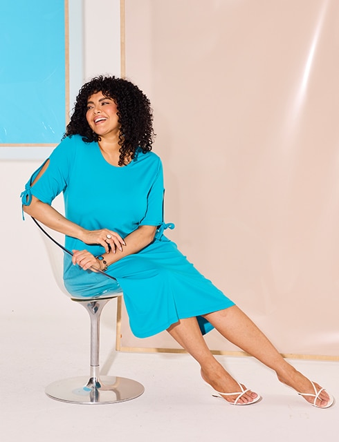 The model is wearing a blue dress.