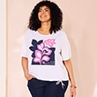 The model is wearing a white shirt with flowers.