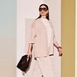 The model is wearing a beige cardigan.