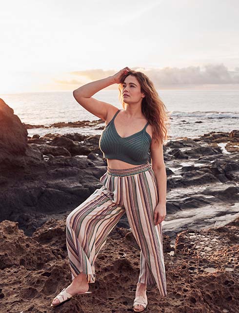 Woman posing in front of the sea while wearing a rib knit bralette
