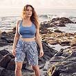The model stands in front of the sea while wearing a pyjama