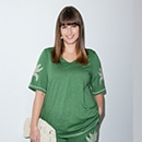 The model is wearing a black and green patterned dress