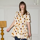 The model wears a yellow patterned dress
