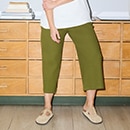 The model wears a green jacket and green pants