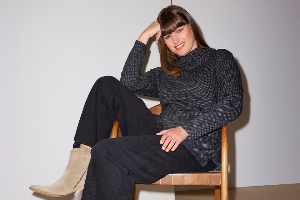 The model wears a gray sweater 
