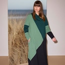 The model wears colorful trousers
