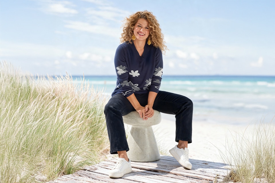 The model wears a blue shirt with blue pants