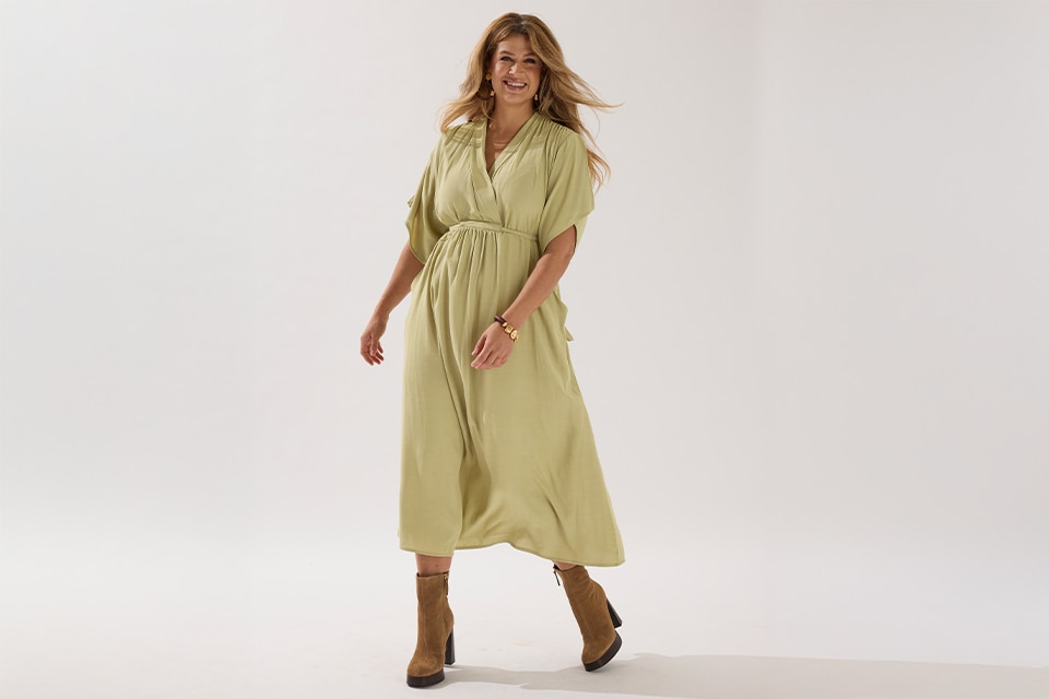 The model wears a green dress