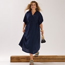 The model wears blue trousers