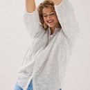 The model wears a blue sweater