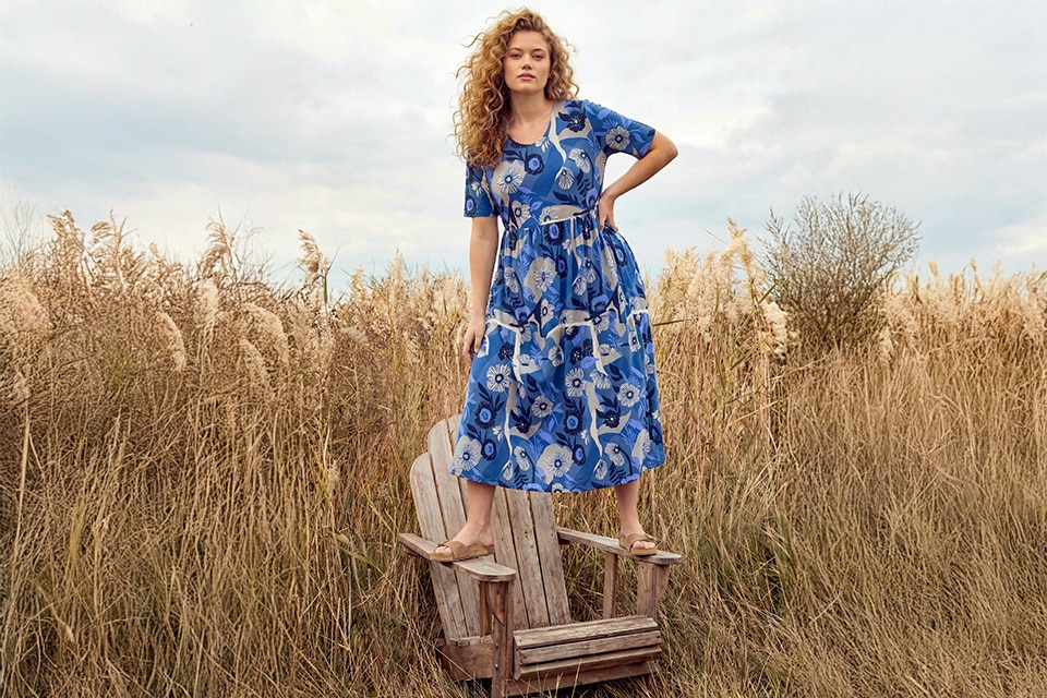 The model wears a jacket and trousers