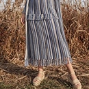 The model is wearing a dark blue dress