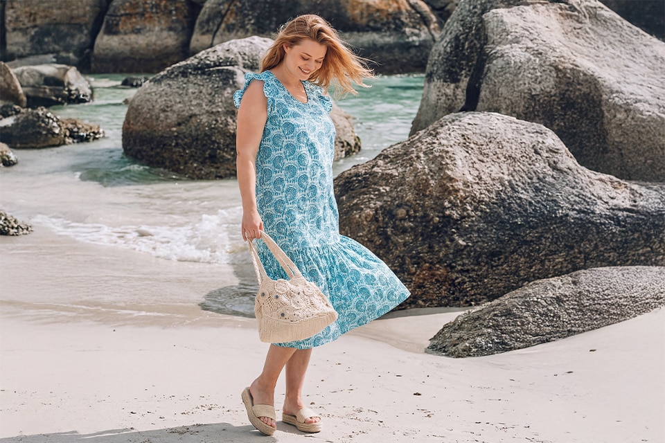 The model wears a blue dress