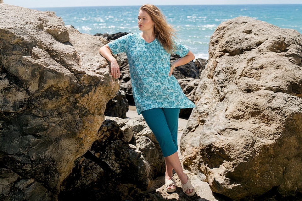 The model wears a green dress