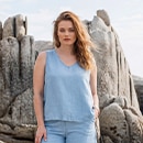 The model is wearing a dark blue dress