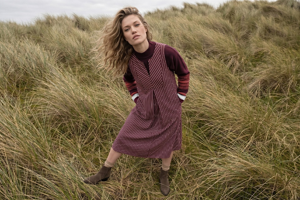 The model is wearing a dress
