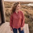 The model wears a dark green shirt.