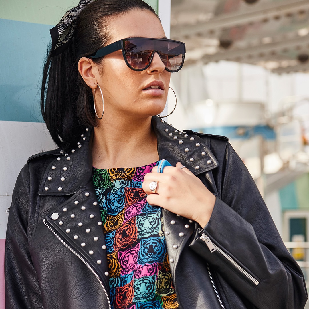 Model wearing sunglasses and a black leather jacket
