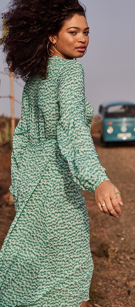 Women wearing a long green dress