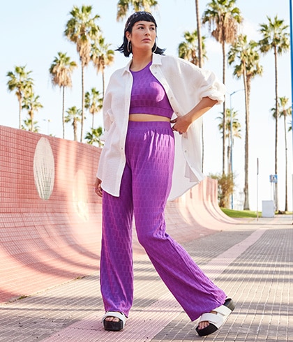 Model is wearing a purple trousers