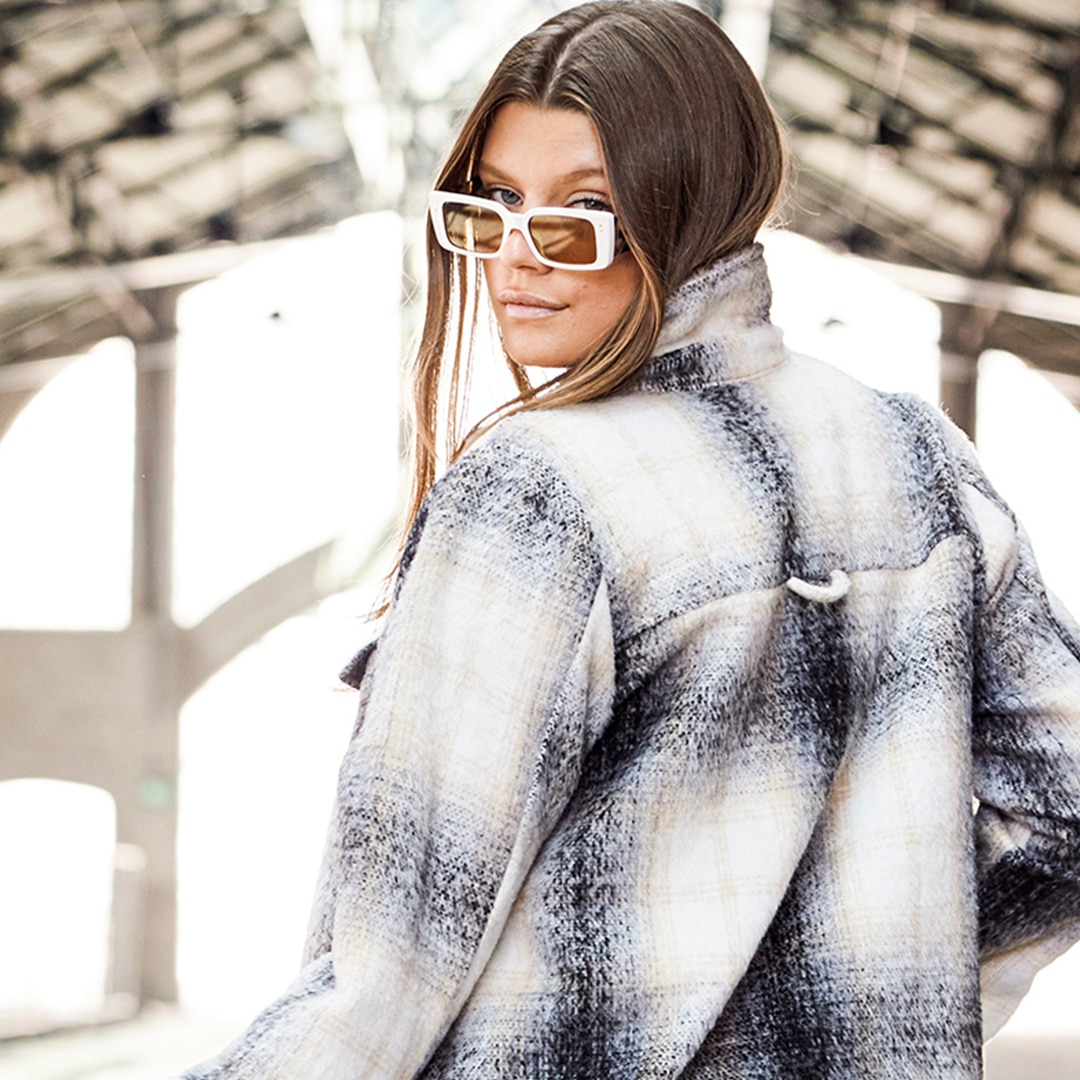 Woman is wearing a plaid oversized jacket